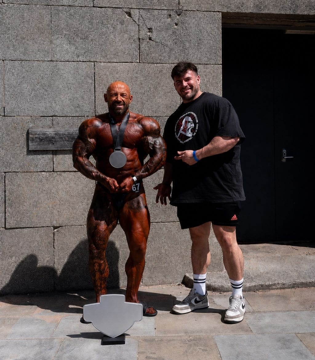 A ProFlow Physiques client in contest condition, holding the medal they won at the show.